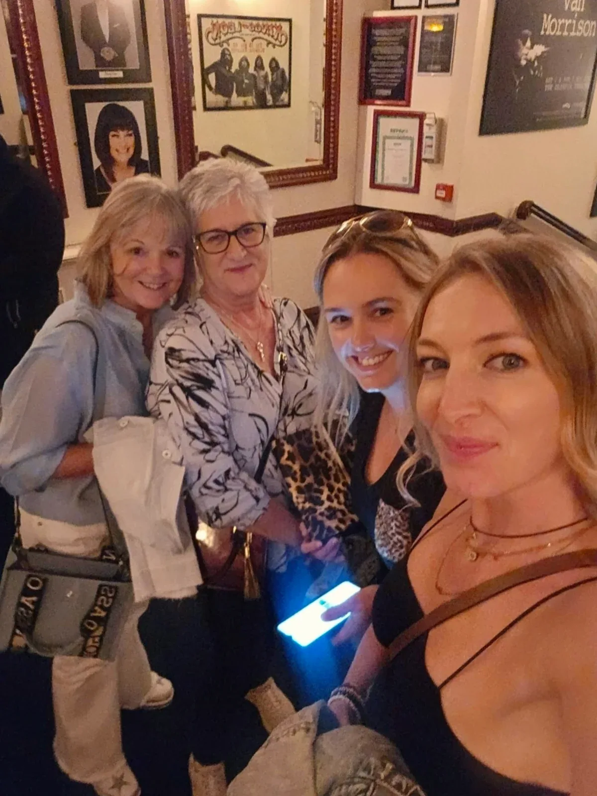 Group of four women posing together indoors