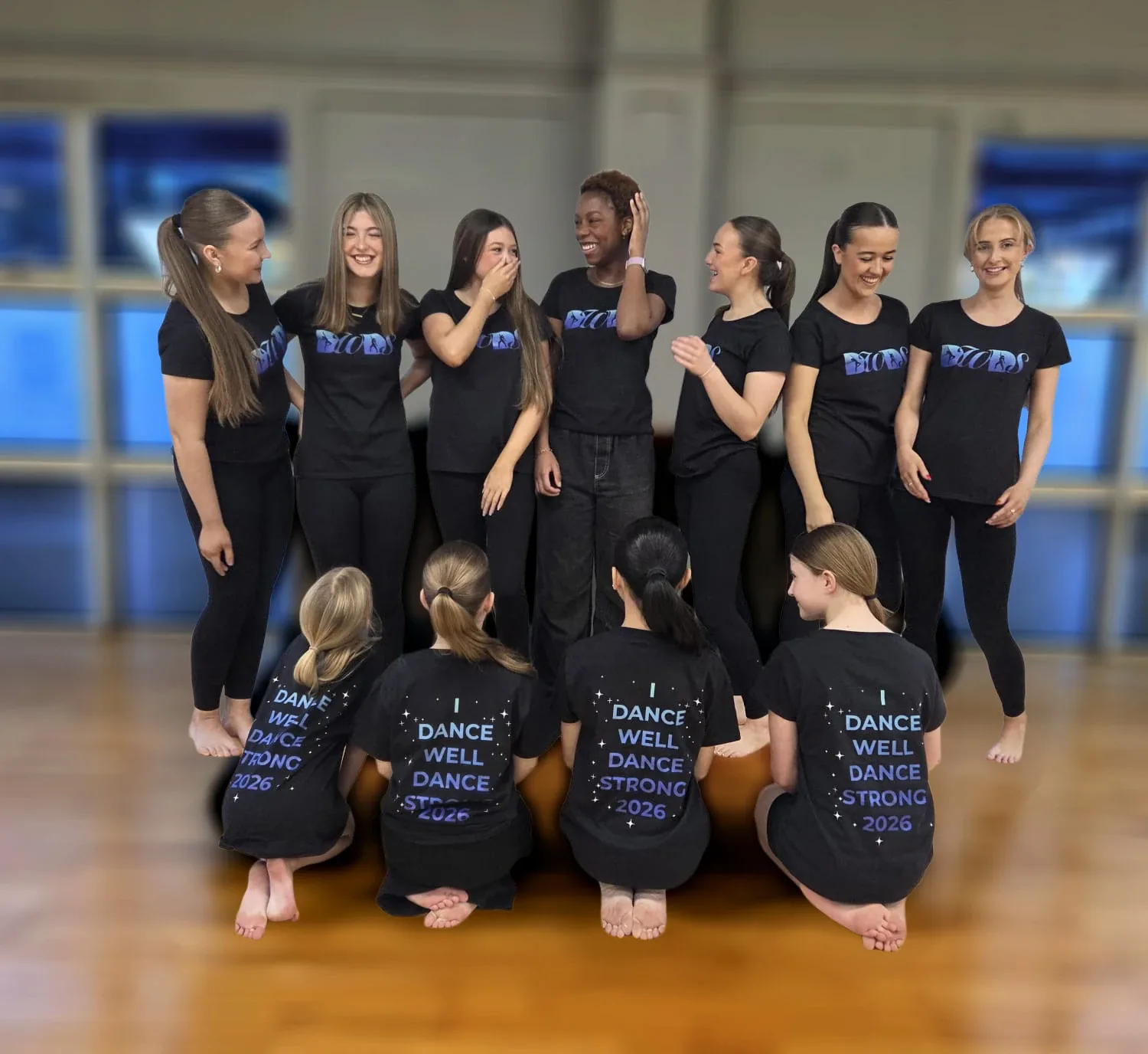 Group of young dancers laughing together in a studio